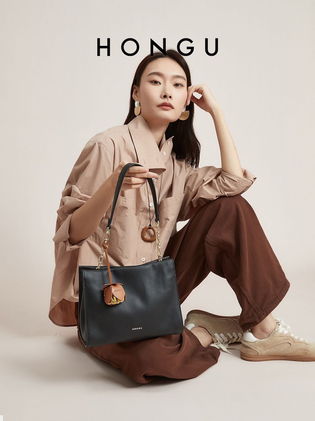 HONGU Cowhide Leather Shoulder Bag in Black - On Female Model