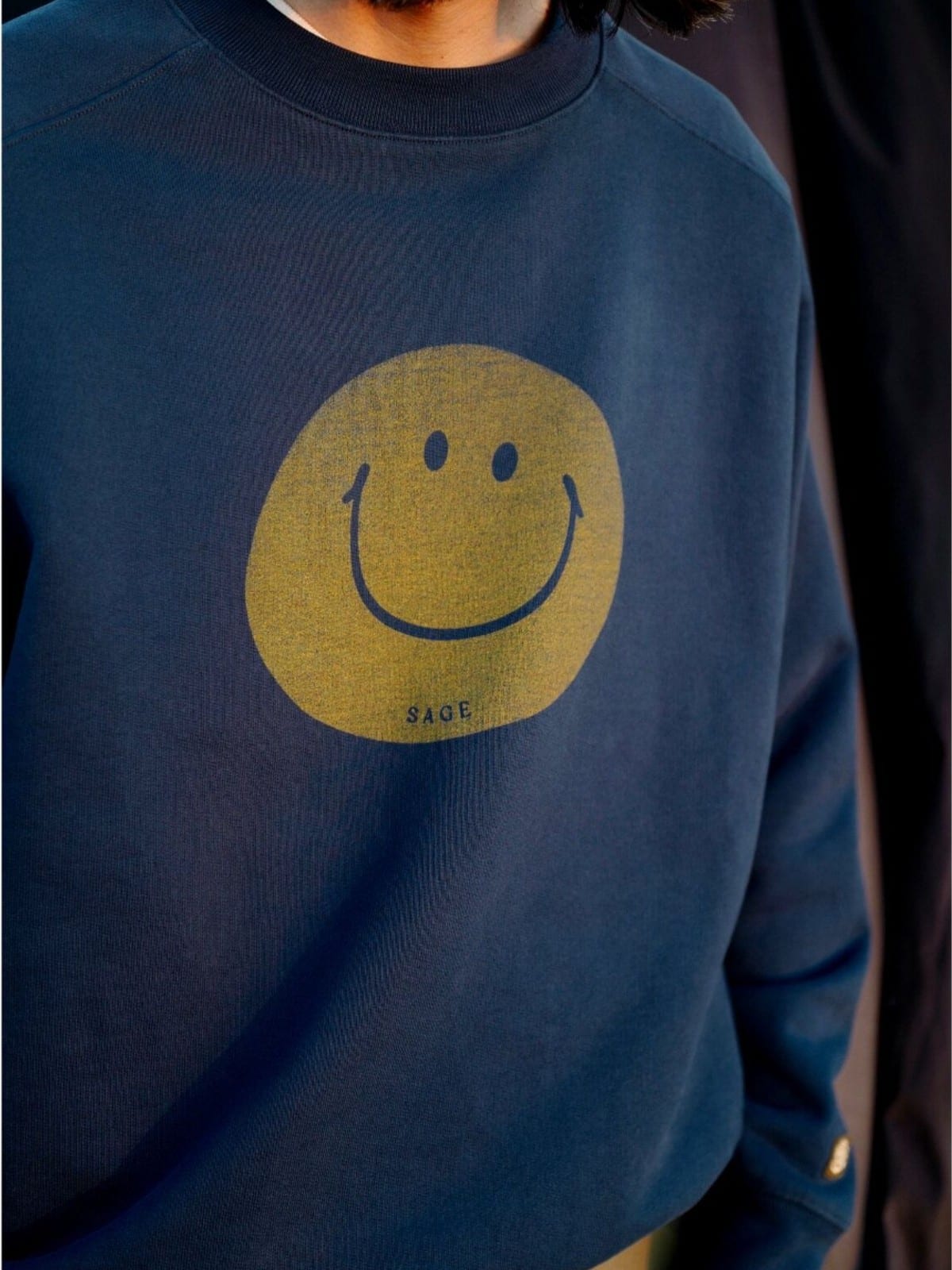 USAGE Washed Cotton Raglan Smiley Sweatshirt in Blue - On Male Model