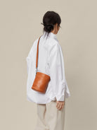 QIUZHEN Leather Drawstring Bucket Bag in Brown - On Female Model