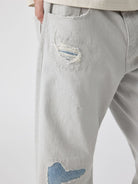 SIMPLE PROJECT Patchwork Distressed Flared Jeans in White - On Model