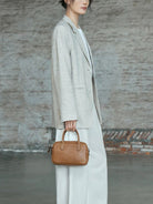 QIUZHEN Vegetable Tanned Leather Bowling Bag in Gray - On Female Model
