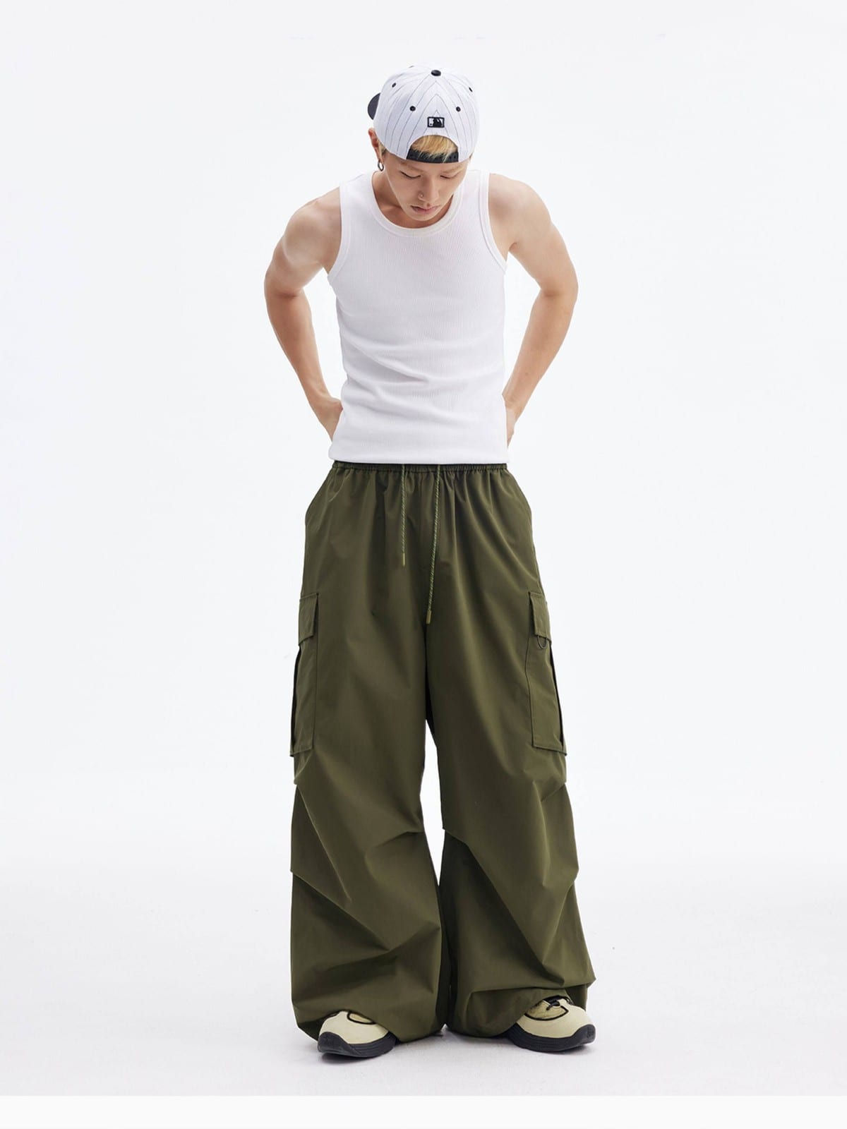 MEDM Multi Pocket Parachute Cargo Pants in Olive - On Male Model