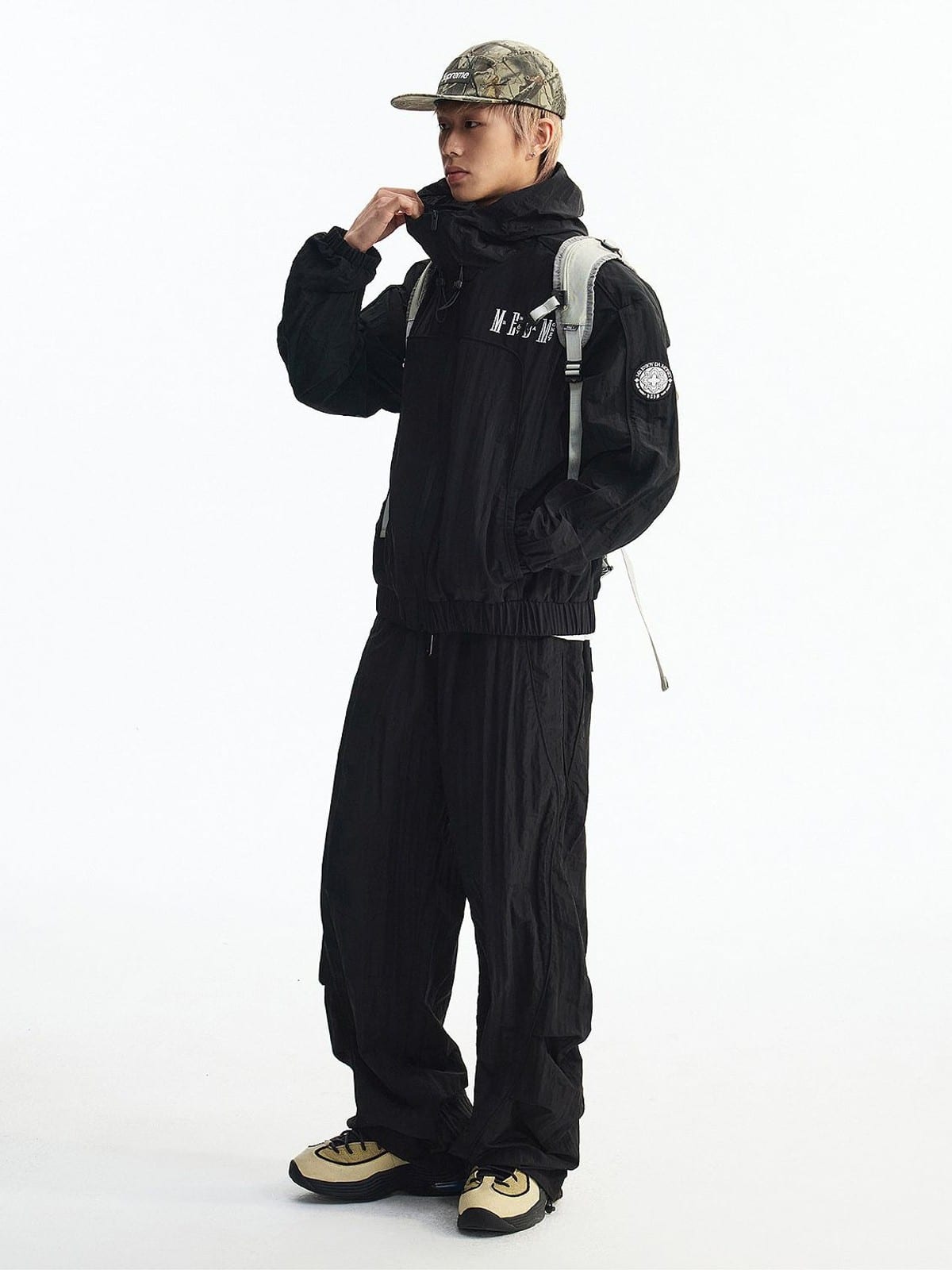 MEDM Glossy Piped Techwear Track Pants in Black - On Male Model