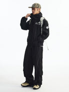 MEDM Glossy Piped Techwear Track Pants in Black - On Male Model