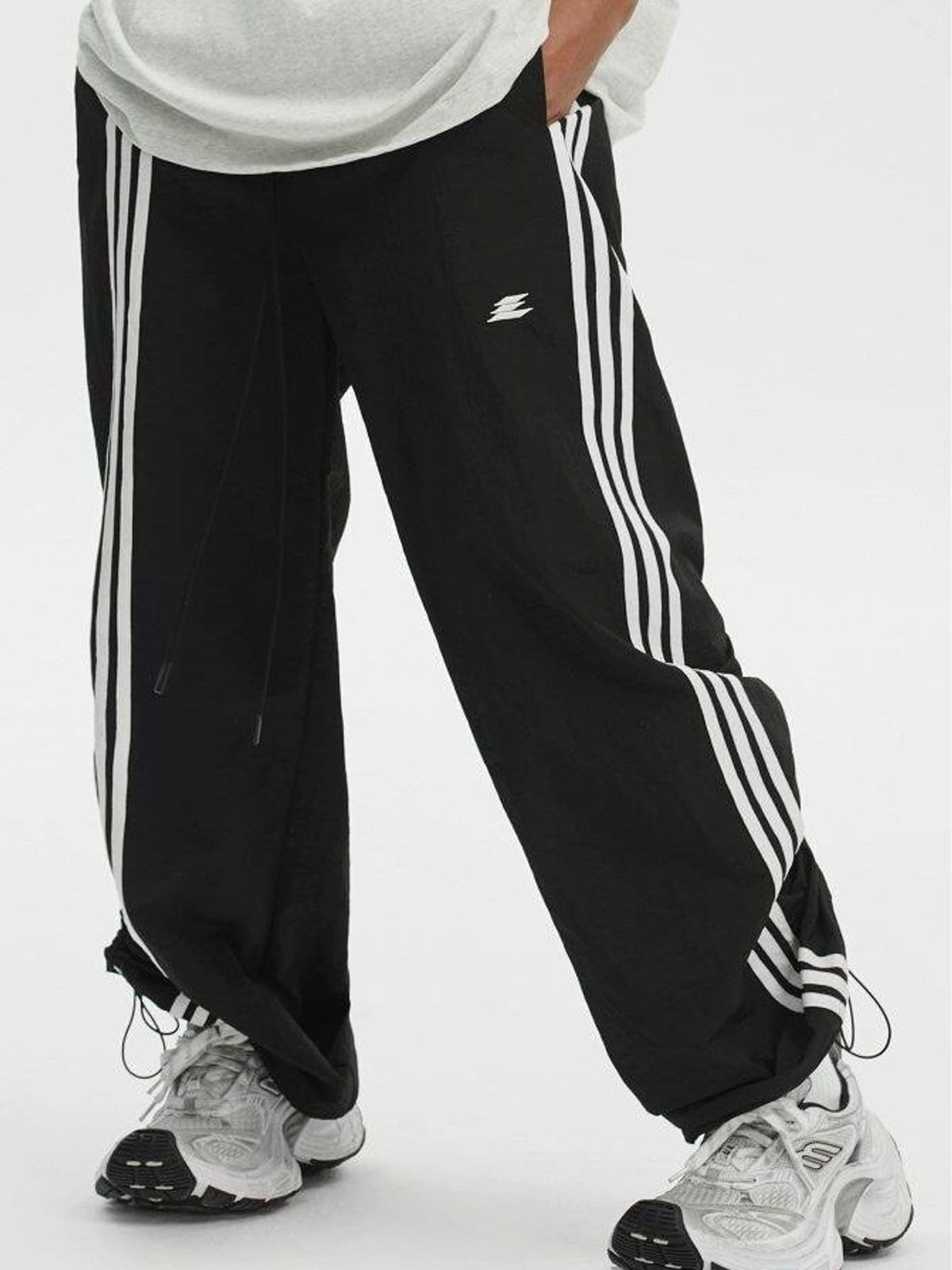 LOSTCTRL Ruched Asymmetrical Striped Track Pants in Black - On Model