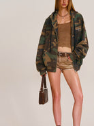 SMFK Cross Embroidered Zip Up Hoodie in Olive - On Female Model