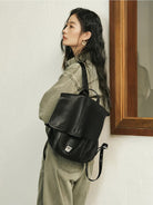 QIUZHEN Vegetable Tanned Goatskin Messenger Backpack in Black - On Female Model