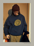USAGE Washed Cotton Raglan Smiley Sweatshirt in Blue - On Male Model