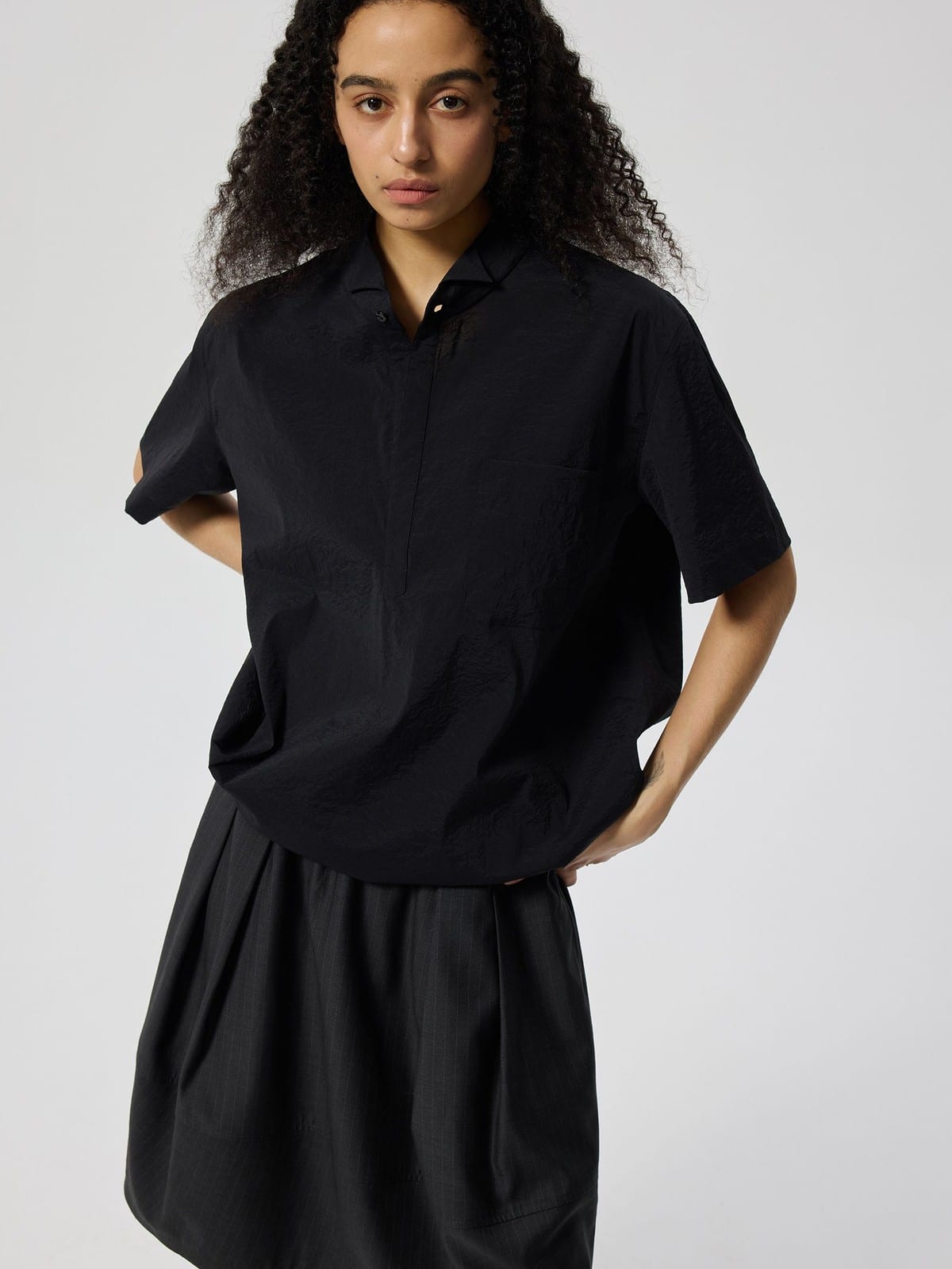 SIMPLE PROJECT Nylon Half Placket Short Sleeve Shirt in Black - On Female Model