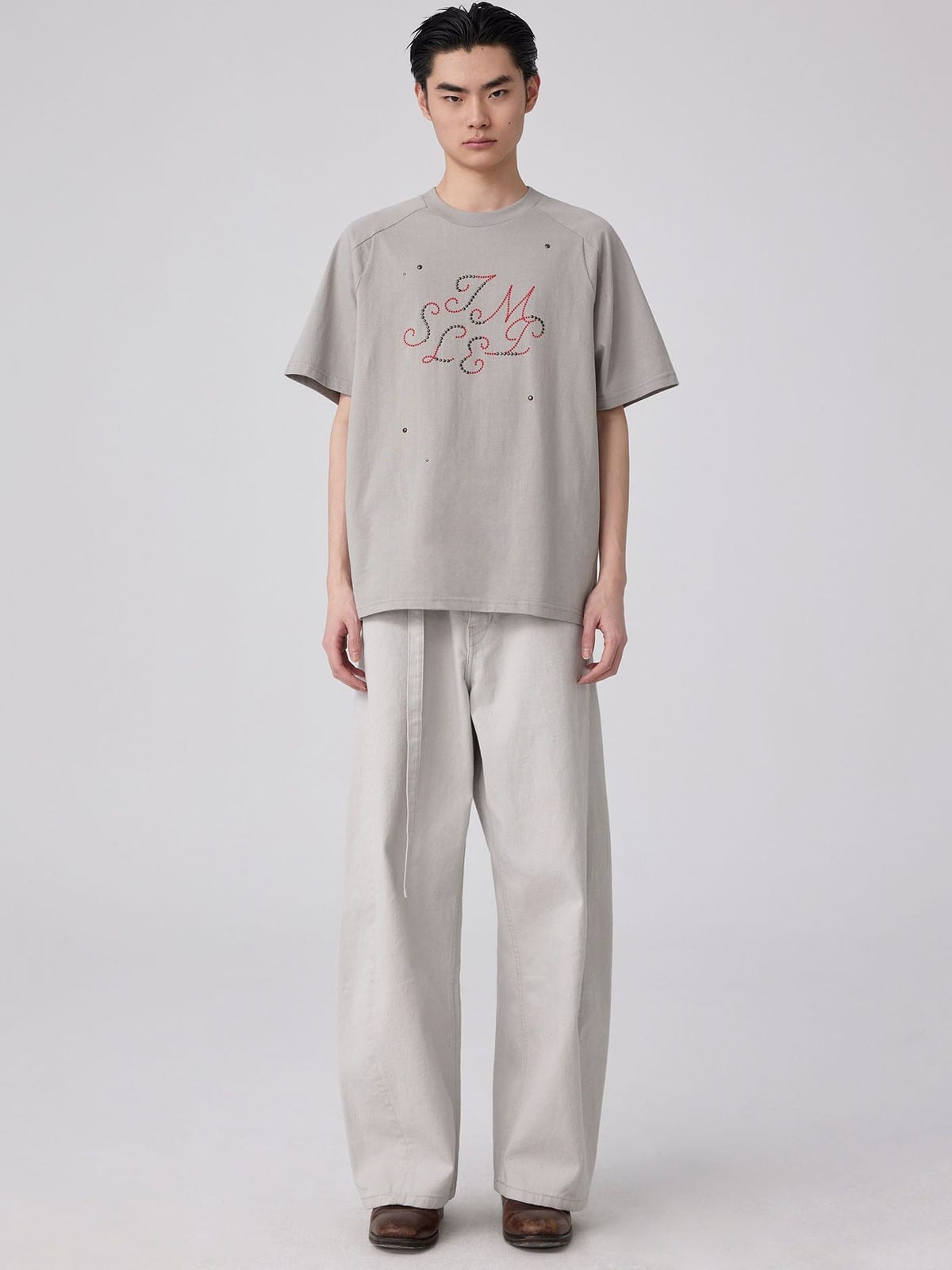 SIMPLE PROJECT Brass Stud Retro Logo Cotton T Shirt in Gray - On Male Model