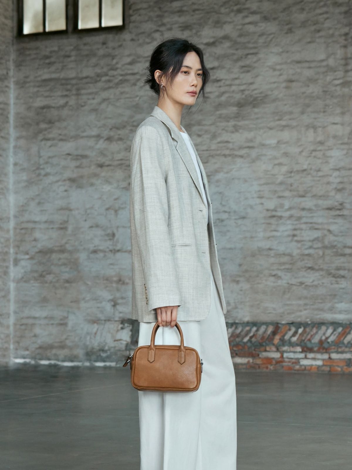 QIUZHEN Vegetable Tanned Leather Bowling Bag in Gray - On Female Model