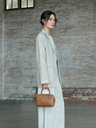 QIUZHEN Vegetable Tanned Leather Bowling Bag in Gray - On Female Model