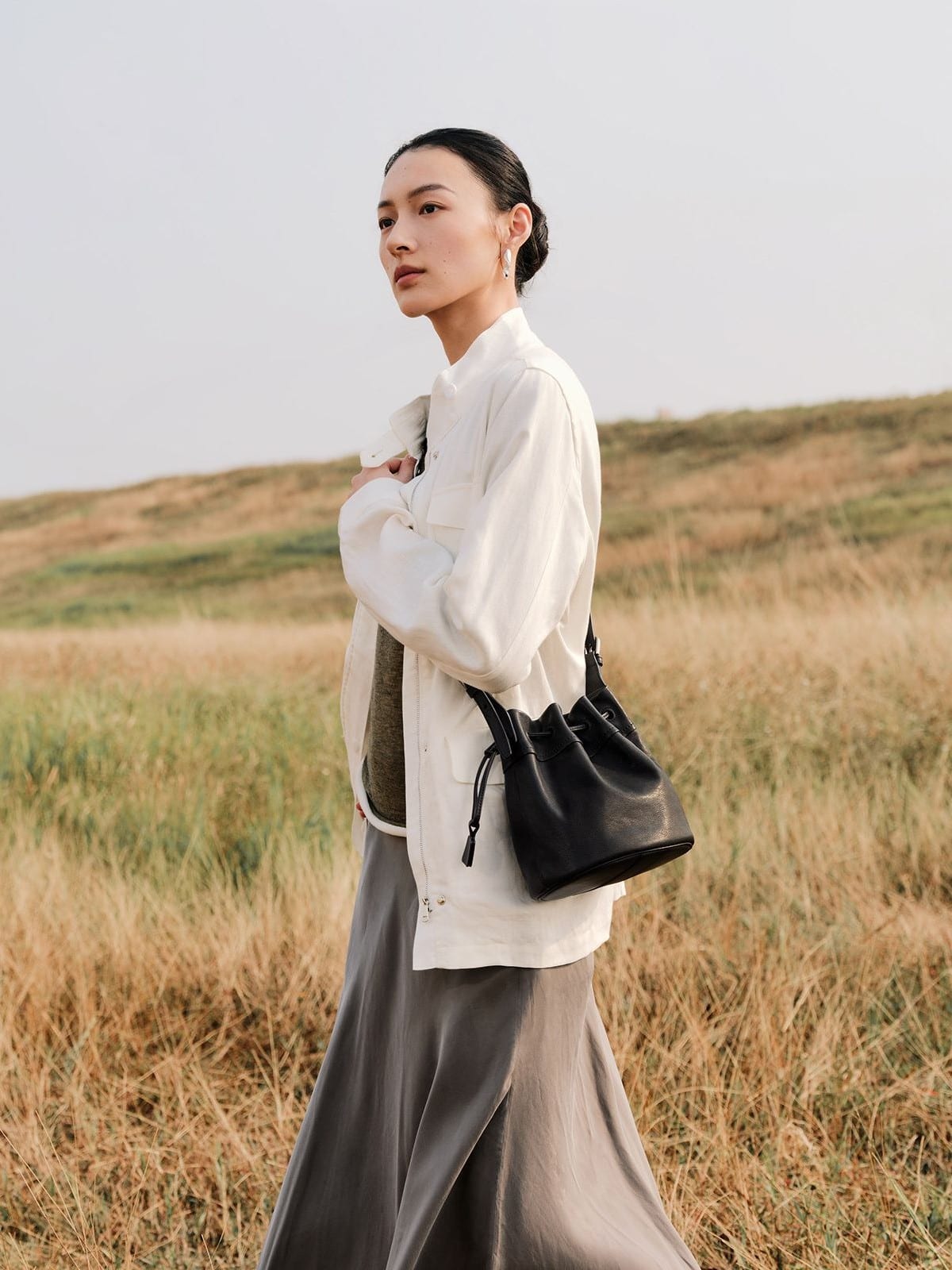 QIUZHEN Kidskin Drawstring Bucket Bag in Black - On Female Model