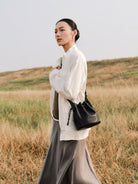 QIUZHEN Kidskin Drawstring Bucket Bag in Black - On Female Model