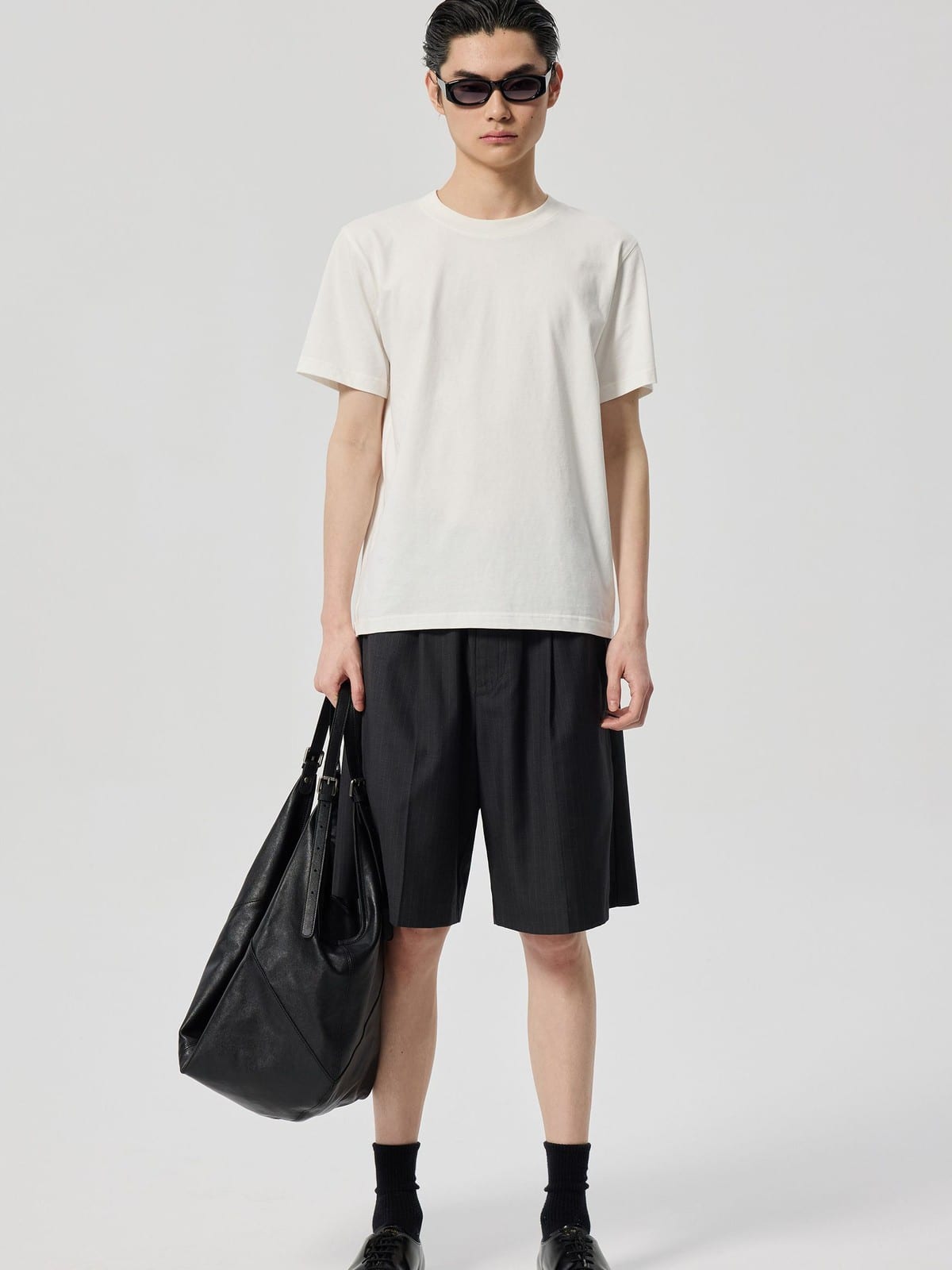 SIMPLE PROJECT Logo Tape Wool Blend Shorts in Gray - On Male Model