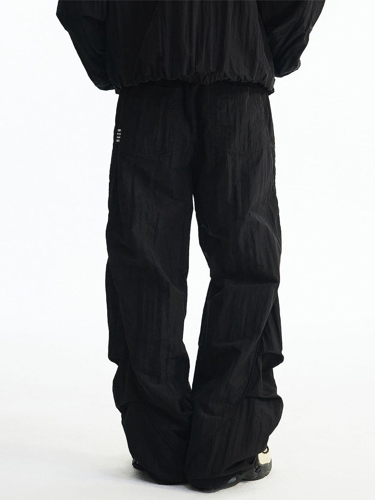 MEDM Glossy Piped Techwear Track Pants in Black - On Model