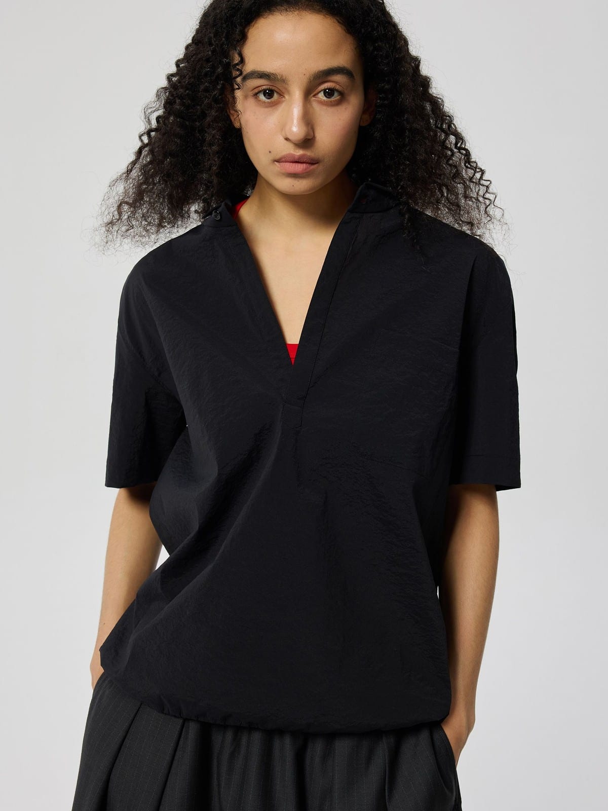 SIMPLE PROJECT Nylon Half Placket Short Sleeve Shirt in Black - On Female Model