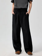 SIMPLE PROJECT Lyocell Blend Curved Leg Trousers in Black - On Model