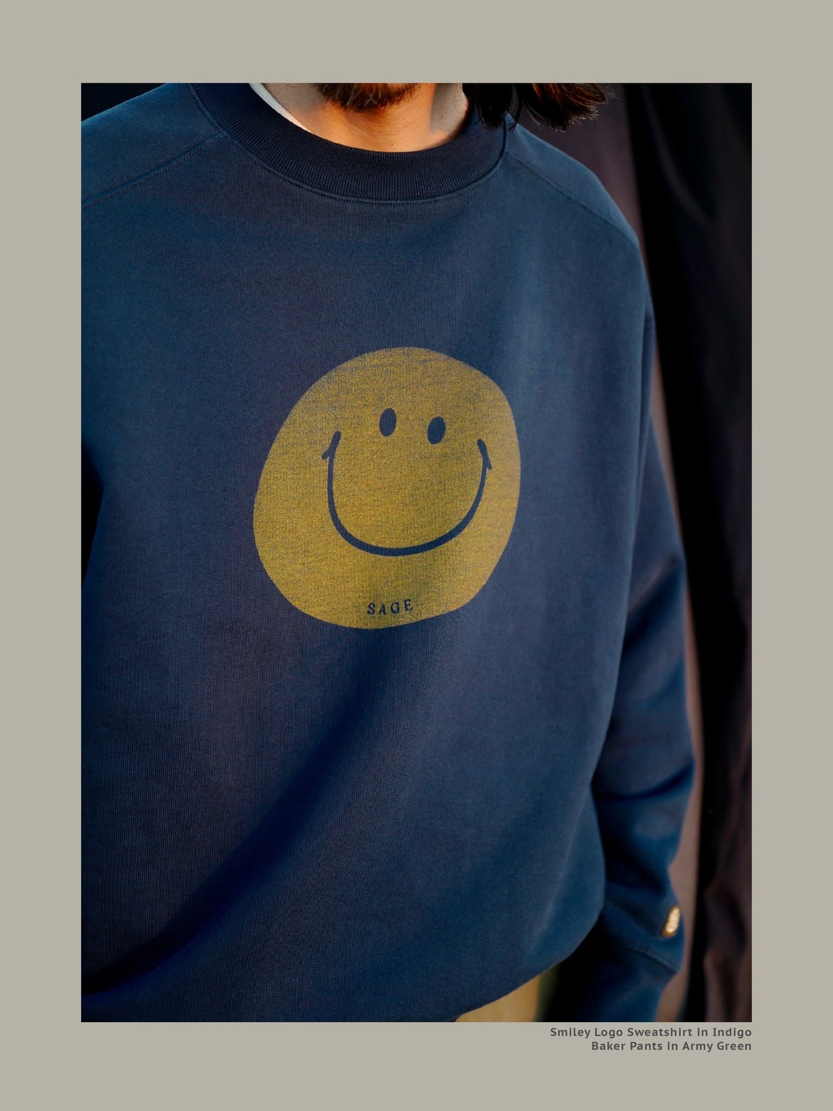 USAGE Washed Cotton Raglan Smiley Sweatshirt in Blue - On Male Model